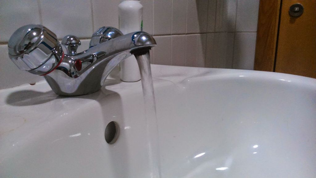 A sink with the tap running. Credit 247homerescue, CC0 1.0 Universal Public Domain.